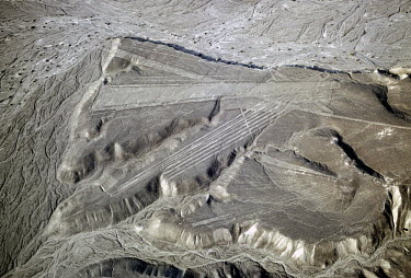 A set of triangles and parallel lines, created by the Nazca culture, ascending a hill from a dry river bed. The pre-Inca Nazca culture flourished in Southern Peru between 200 BCE and 600 CE. It produc...