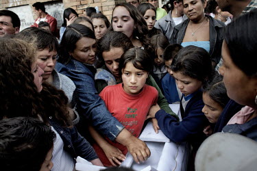 Friends and family gather for the funeral of a five year old boy in the Soacha slum area of Bogota. He and his eight year old sister were killed by the paramilitary. The eight year old girl was strang...