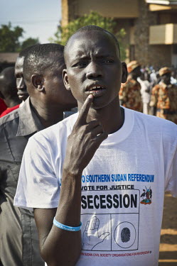 People wait in line to cast their votes. A man wears a t-shirt in favour of secession. On 9th January 2011 Southern Sudan's people began voting in a referendum on whether to become independent from th...