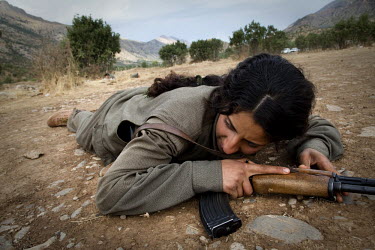 A PKK (Kurdistan Worker's Party) soldier takes cover during a training exercise in the Qandil Mountains. Labelled as terrorists by the Turkish, US and EU, it's in the Qandil Mountains near the border...