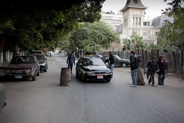 Residents in the middle class Zamalek neighbourhood set up a road block. 25 January 2011 saw the beginning of a non-violent 18 day protest movement that eventually ended the 30-year rule of Hosni Muba...