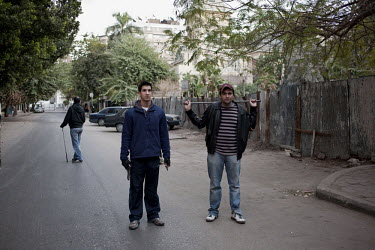 Young residents including one holding a gun and a knife set up a road block in the middle class Zamalek neighbourhood. 25 January 2011 saw the beginning of a non-violent 18 day protest movement that e...