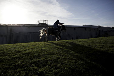 A boy rides his horse on Belcamp estate.