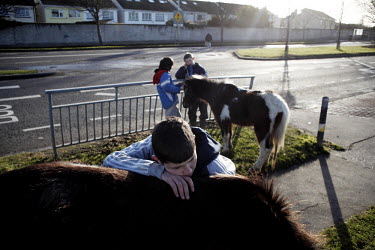 A boy stands with his horse on Belcamp estate.