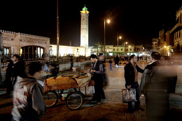 A street seller sells spices in front of the Great Mosque in the heart of Aleppo's old town.