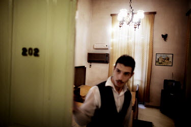 Staff at the old and classical Baron Hotel in Aleppo closes the door to the room which was used by T. E. Lawrence of Arabia.
