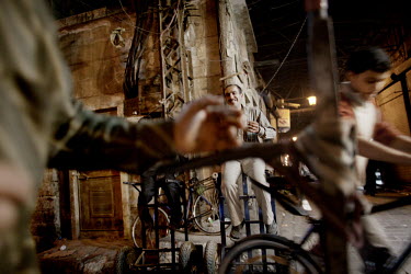 Workers with their trolleys wait for work on a street corner at a souk in Aleppo's old town.