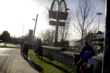 Boys ride their horses next to a McDonald's Restaurant on Belcamp estate.