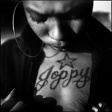 A young woman shows her tattoo of the local spelling of Joppa, �Joppy�. Joppa, Texas.