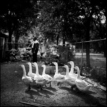 Cecil raises and cares for ducks and chickens like pets, which he keeps in his yard. Joppa, Texas.