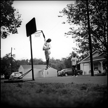 Children play basketball on the street in Joppa, Texas.