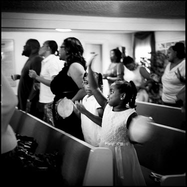 People sing and dance in a church in Joppa, Texas. There are no schools, and no stores in Joppa, but lots of churches, the majority of which are Southern Baptist.