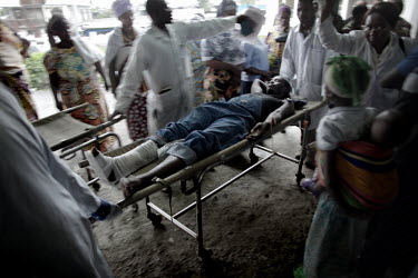 An injured man arrives at the hospital in Goma. During the fighting, civilians were caught in the crossfire between government troops and rebels led by General Nkunda.