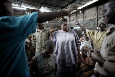 People sing prayers in a small chapel at Mugunga II IDP (Internally Displaced Person) camp. More than 100,000 people have fled their villages and towns as fighting reignited between rebels and the Con...