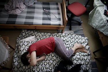 Rahman sleeps on a mattress on the floor in his room, it reminds him of the days when he lived in Iran. He is usually up late in the night, and uses the weekends to rest. 17 year old Rahman is from th...