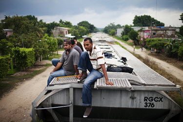 A group of migrants on a the roof of a train in Palenque, Chiapas.