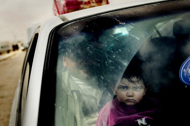 A child seen through the windscreen of a car as a family cross the border into Egypt, escaping the violence in Libya. According to sources, approximately 10,000 people cross the border into Egypt ever...
