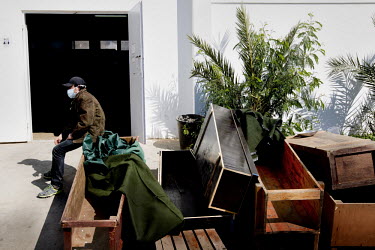 A man rests on coffins in front of the morgue at Jalo general hospital in Benghazi. They contained parts of ten people that came to the hospital. The hospital claims that they were Gadaffi's soldiers,...