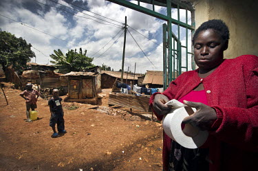 Mary Ambogo sells toilet paper by the sheet to customers who visit the public toilet facilities in Kibera, the biggest slum in Nairobi.