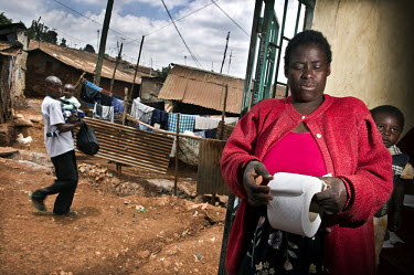 Mary Ambogo sells toilet paper by the sheet to customers who visit the public toilet facilities in Kibera, the biggest slum in Nairobi.