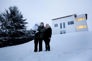 Cecilie stands in the snow with her husband and son outside their house in Gentofte. Cecilie was the legal guardian of Nepalese orphan Victoria. 19 month old Victoria (formerly named Ghane) was born w...
