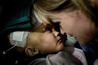Cecilie embraces Victoria after her first surgery at Annapurna Neurological Institute in Kathmandu. 19 month old Victoria (formerly named Ghane) was born with hydrocephalus and was left abandoned. Cec...