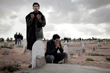 Young men mourn at a funeral for 20 year old rebel Najm Briwa who was killed during a fight against pro Gaddafi forces. He and some of his comrades were driving in a car towards the front when they we...