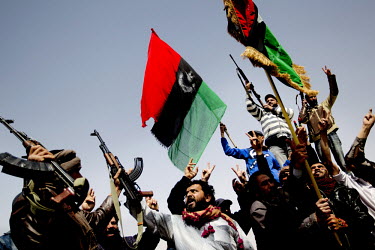 Rebel fighter celebrate the retaking of the strategically important town of Ajdabiya from pro Gadaffi forces. They wave the flag of liberated Libya. On 17 February 2011, an uprising against the 41 yea...