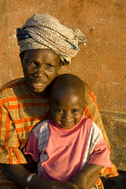 A woman sits with her grandson.