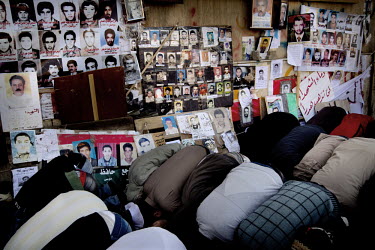 Men kneel down at Friday prayers in Benghazi, next to pictures of missing people. On 17 February 2011 Libya saw the beginnings of a revolution against the 41 year regime of Col Muammar Gaddafi.