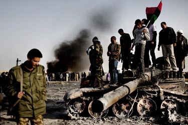 Rebels stand on a destroyed tank as they celebrate the retaking of the city of Ajdabiya. This was enabled by NATO airstrikes on government targets. On 17 February 2011 Libya saw the beginnings of a re...