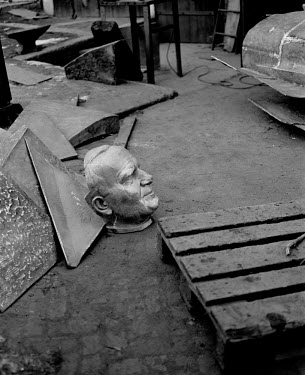 The bronze head of Pope John Paul II lies on the floor, prior to being welded to the body, at the studios of Polish artist, sculptor, and professor Czeslaw Dzwigaj. The final figure will join over 70...
