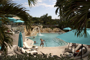 People relax at a pool at the Boca West Country Club, Florida. One of the first of its kind, this gated community is home to over two thousand middle and upper class people. Only residents and their g...