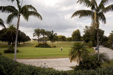 A man plays golf at the Boca West Country Club, Florida. One of the first of its kind, this gated community is home to over two thousand middle and upper class people. Only residents and their guests...