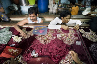 Men in a small embroidery workshop in Dharavi decorate textiles that have been ordered for a wedding in one of the Gulf States.