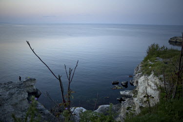 A man fishes in the Black Sea.
