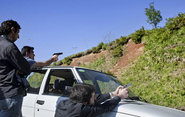 A group of young Laz men fire guns into the hillside after enjoying a picnic. The Laz are a Caucasian ethnic group living on the Black Sea coastal regions of Turkey and Georgia.
