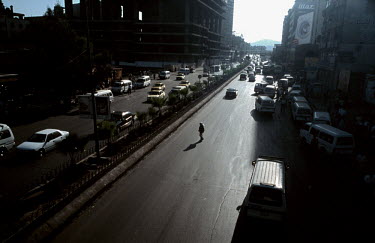 A man crosses a road in Central Damascus.