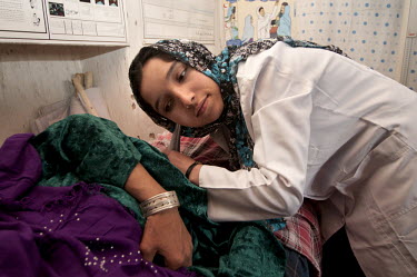 Souhaila, a graduate of the Taloqan CME (continuing medical education) Midwife Training School, examines Bibi Khalam who is 5 months pregnant. Afghanistan has one of the highest fertility rates in the...