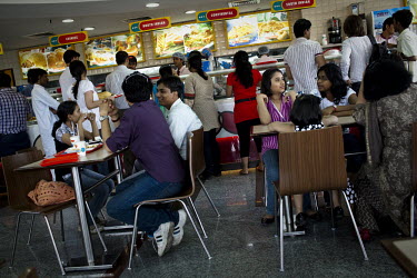 Middle class youth eat at a fast food restaurant in Netaji Subhash Place, a commercial complex in Pritam Pura, New Delhi.