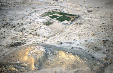 Green, irrigated fields stand out from the surrounding desert at Salut. The site (the raised area to the bottom) is also being excavated by the University of Pisa, Italy and was possibly the capital o...