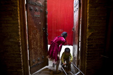 Residents pass time in old city in Kashgar. The old city, where Uighur (Uyghur) people have lived and worked for centuries, is being demolished for reconstruction under the government's project to gua...