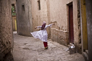 A girl dances on a street in the old city in Kashgar. The old city, where Uighur (Uyghur) people have lived and worked for centuries, is being demolished for reconstruction under the government's proj...
