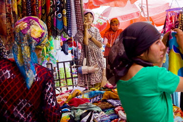 Uighur (Uyghur) women shop at a market in Hotan.