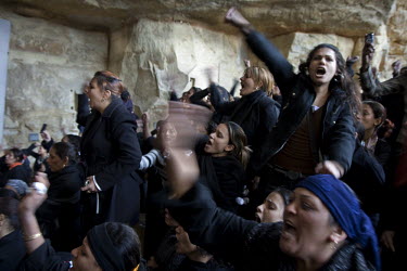Women scream at a Coptic Christian mass funeral at St Simon the Tanner's Church in Mokattam, Cairo. The funeral is for 11 young protesters who were killed by the army during a protest against the burn...
