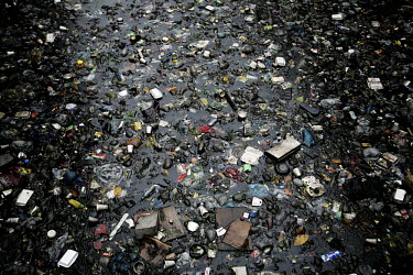 Rubbish floating in a river. Poor families rely on the river for drinking water.