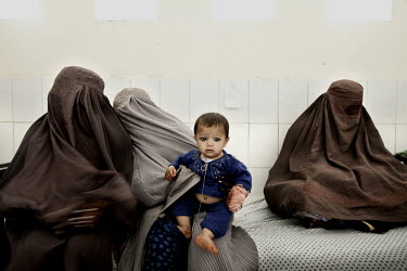 Three women completed hidden beneath their burqas wait with a toddler for treatment in the Bost (Boost) Hospital.
