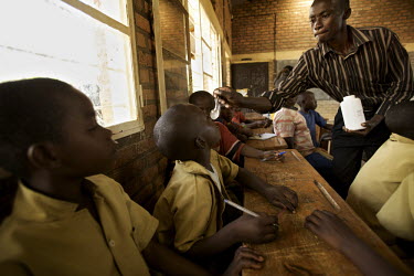Children in schools are given tablets during the Mother and Child Health Week held in April 2010. This includes a mass drug administration against intestinal worms and schistosomiasis. Around 14 milli...