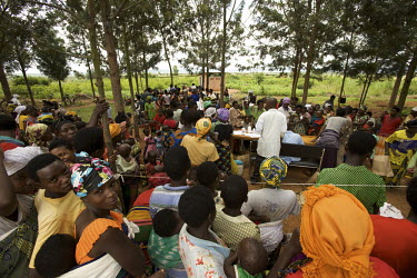 Women and children queue to collect tablets during the Mother and Child Health Week held in April 2010. This includes a mass drug administration against intestinal worms and schistosomiasis. Around 14...