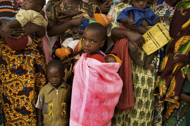 Children wait to collect tablets during the Mother and Child Health Week held in April 2010. This includes a mass drug administration against intestinal worms and schistosomiasis. Around 14 million 16...